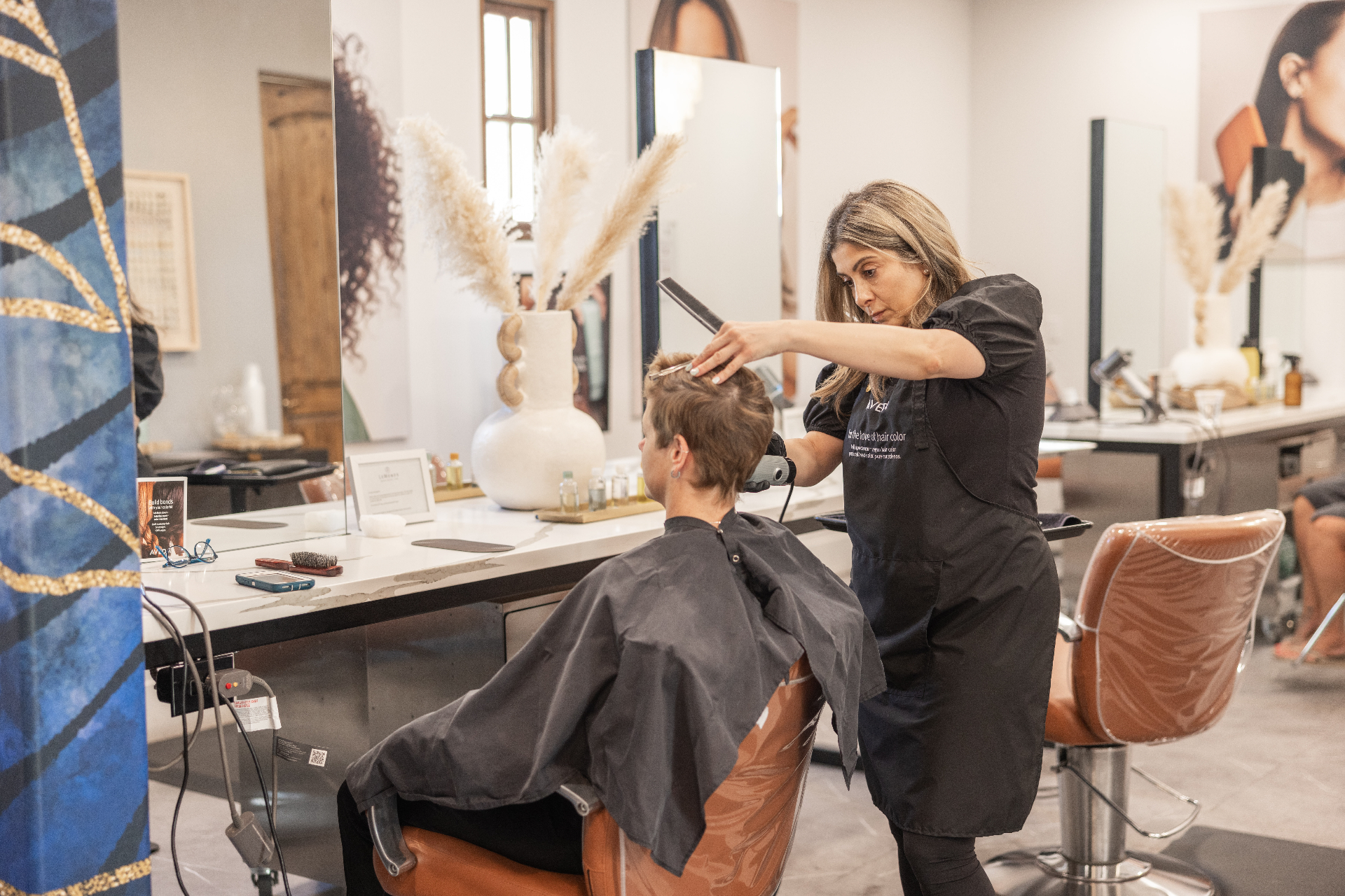 Stylist cutting hair in a modern salon chair